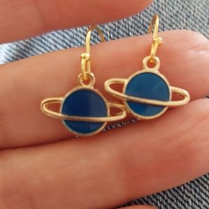 Blue enamel Saturns hang on gold tone wire hocks